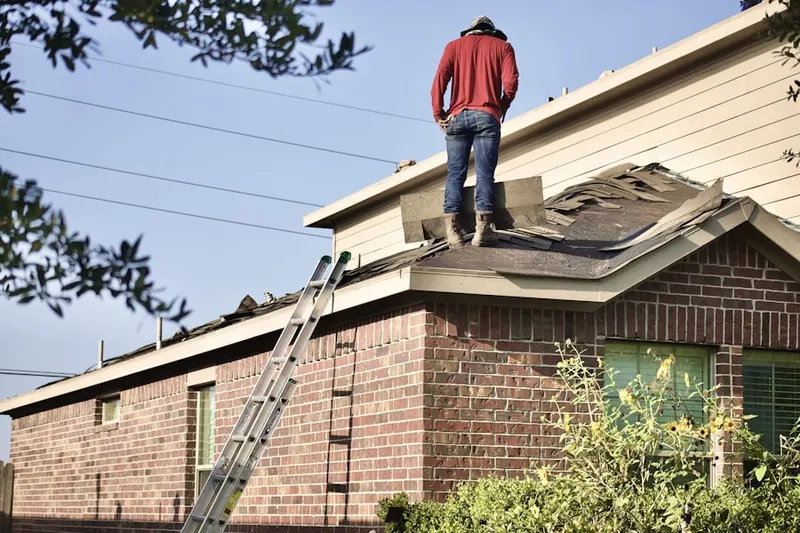 Professional roofer working on a residential roof in Rivercrest Manor